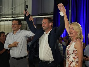 Conservative Leader Pierre Poilievre, left, and former MP Candice Bergen, right, show their support for Conservative candidate Branden Leslie, centre, in Winkler, Man.