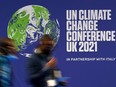 Delegates pass a sign for the UN Climate Change Comference