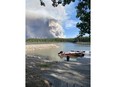 A plume of smoke rises from a wildfire burning near Leaf Rapids, Man., in an undated handout photo. The town declared a state of emergency Monday evening and directed its roughly 350 residents to head to the city of Thompson.